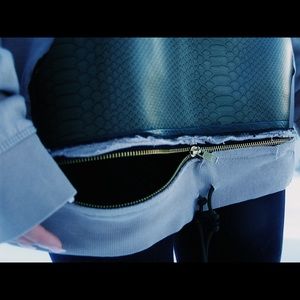 Custom cut and sew leather pocket sweatshirt.